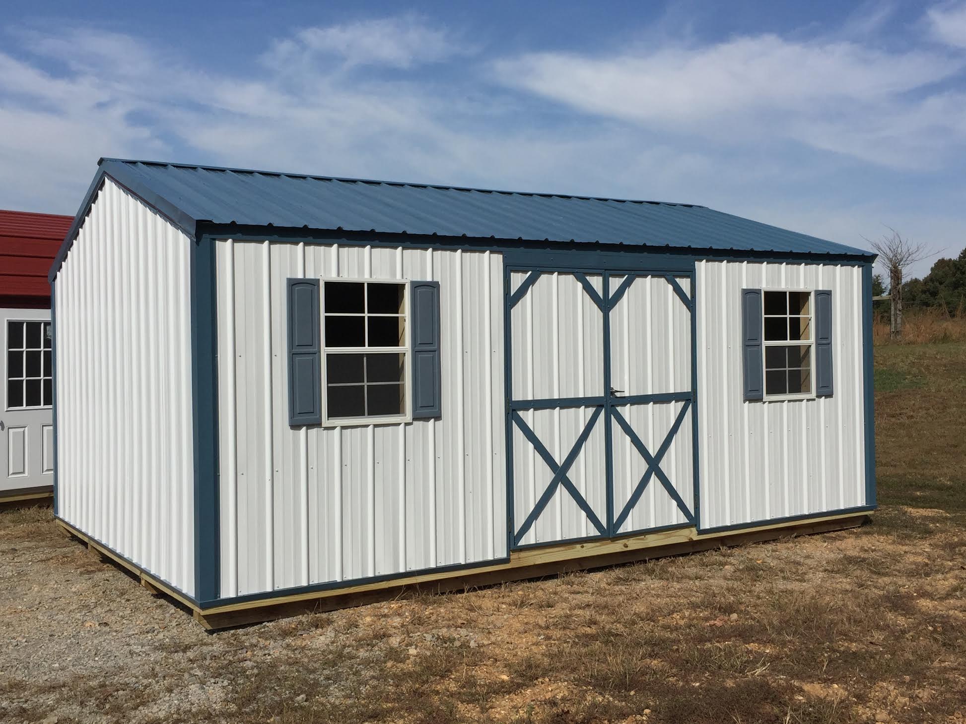 White metal true garden shed with blue trim and roof