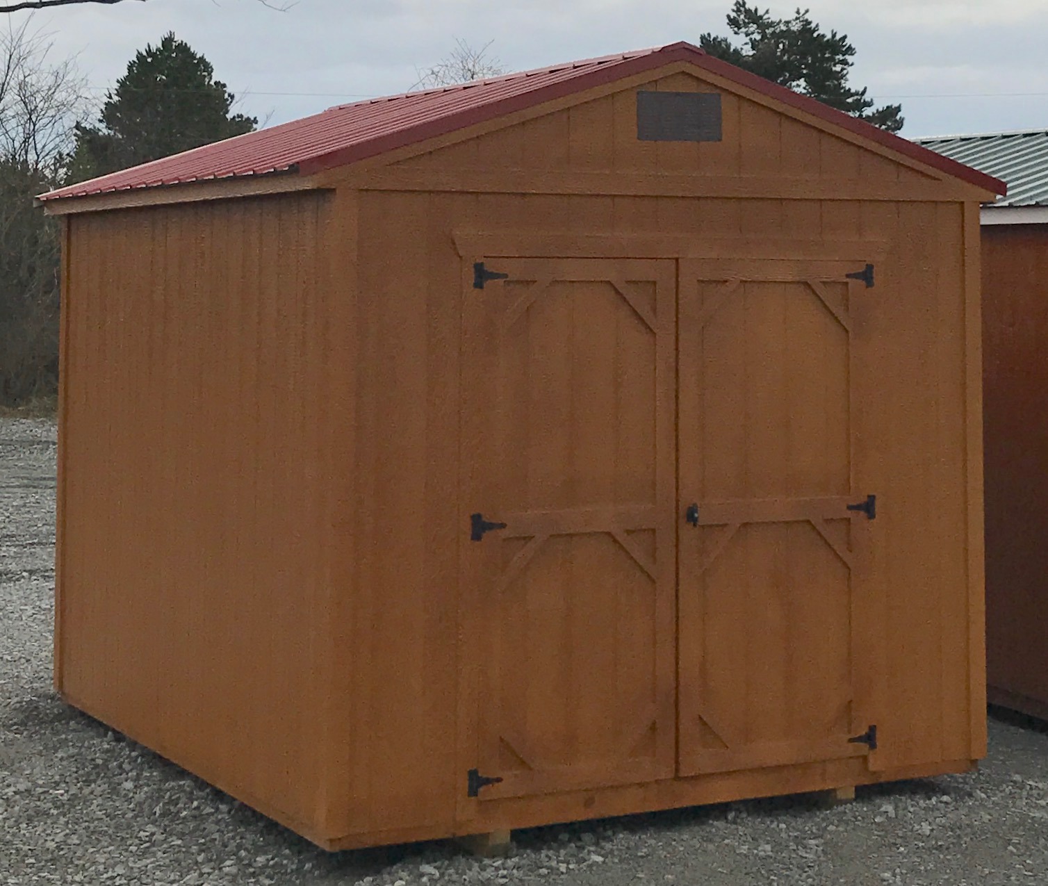 Urethane utility shed with maroon roof