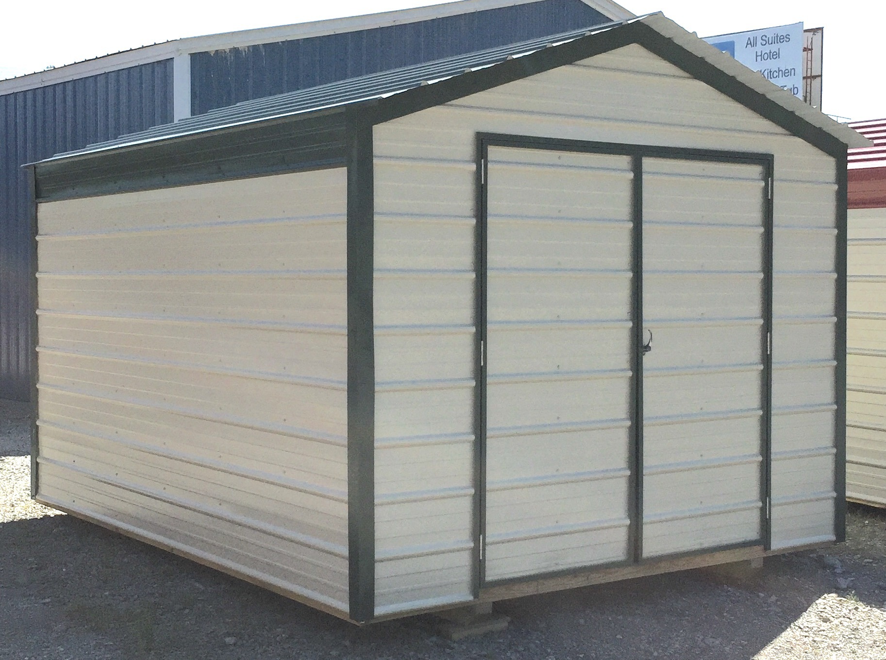 Tan metal economy series shed with black trim and roof