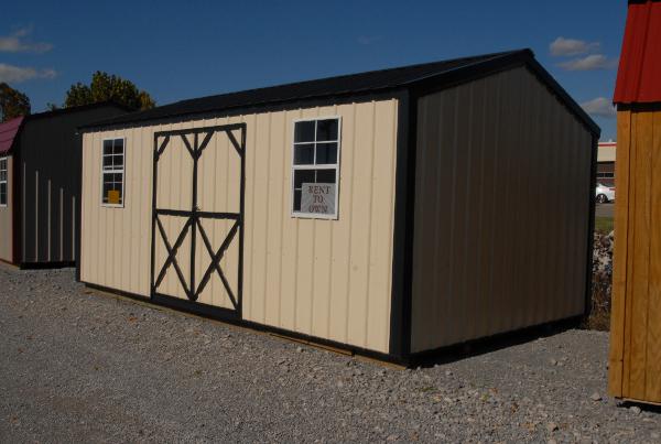 Tan metal garden shed with black trim and roof