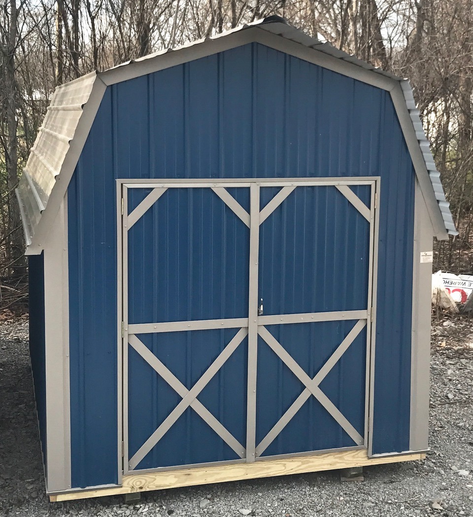 Blue metal lofted economy series shed with white trim and roof