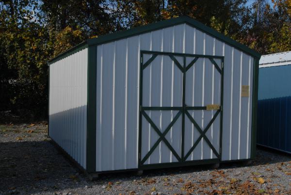 White white utility shed with green trim