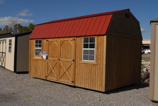 Treated side lofted barn with red metal roof