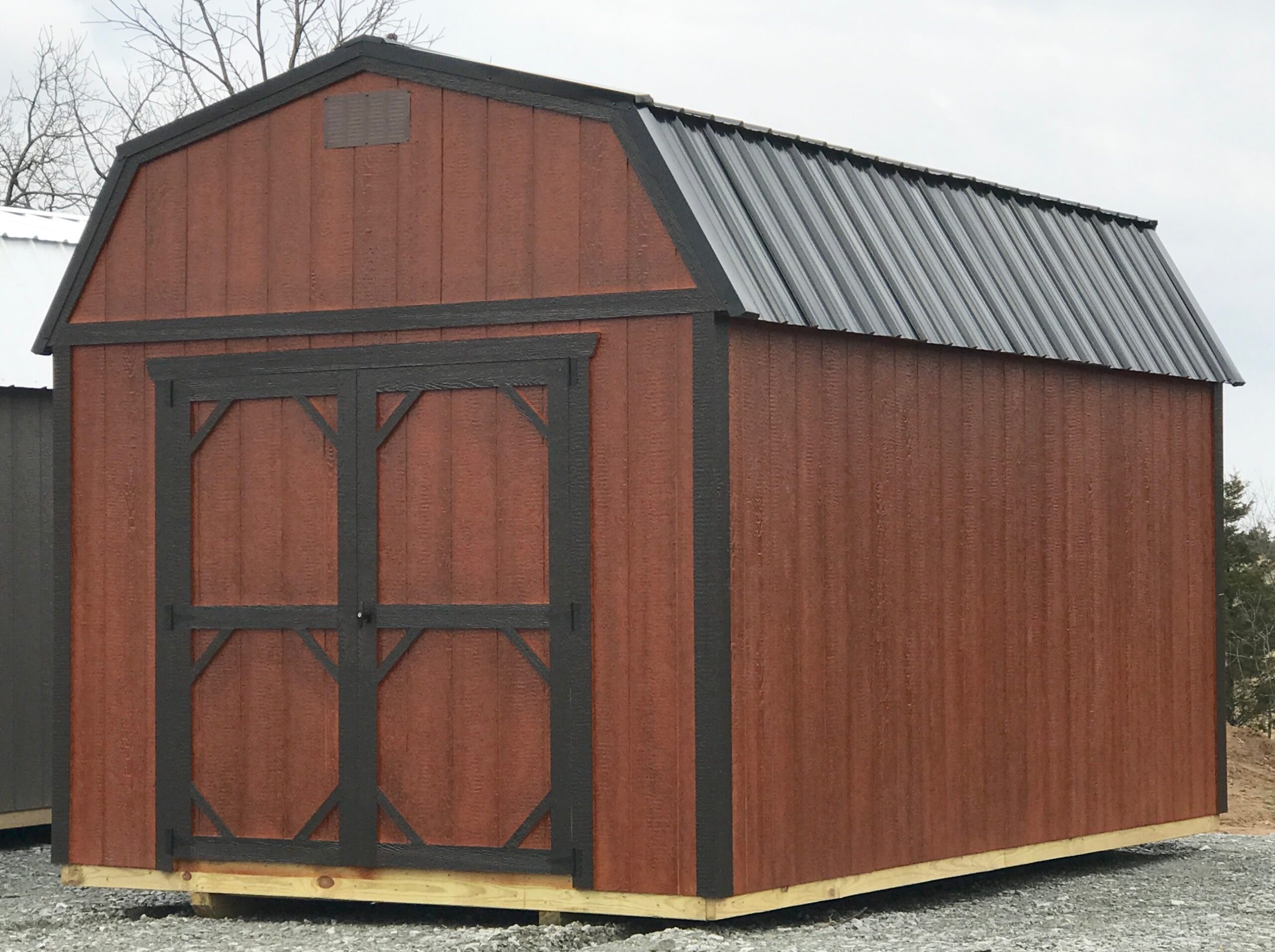 Urethane lofted barn with black trim and metal roof