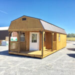Premium lofted barn cabin with treated siding and wrap around porch