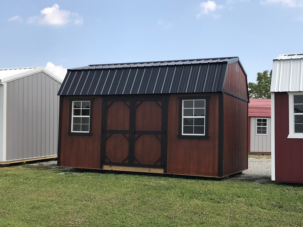 Brown urethane side lofted barn with black metal roof